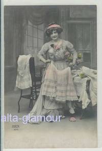 Item #7491 Original color photograph in postcard format depicting a woman posed amid various frilly under garments
